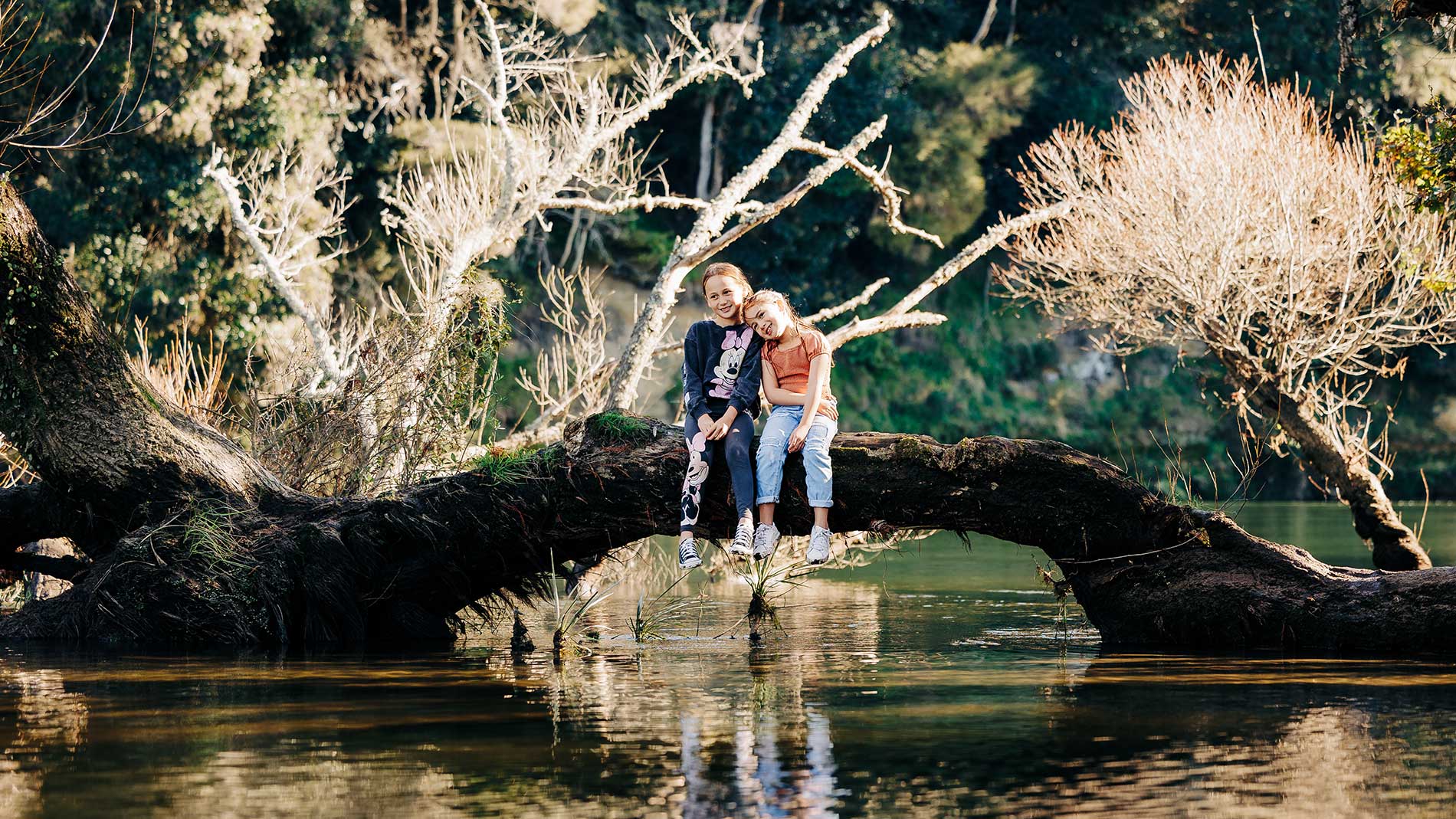  Image - children sitting on tree over stream