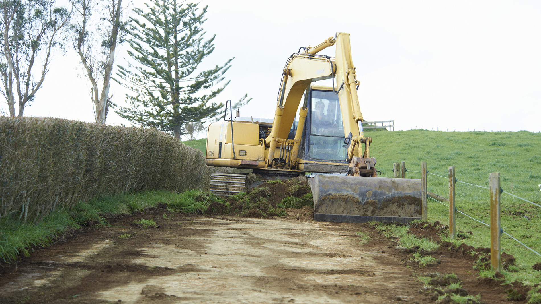 Image - Yellow digger moving soil and grass