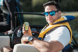 A man holding a radio on a boat