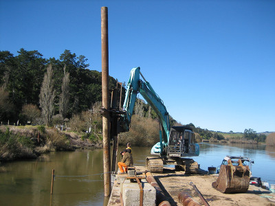 The floating platform supports construction of infrastructure along the river.