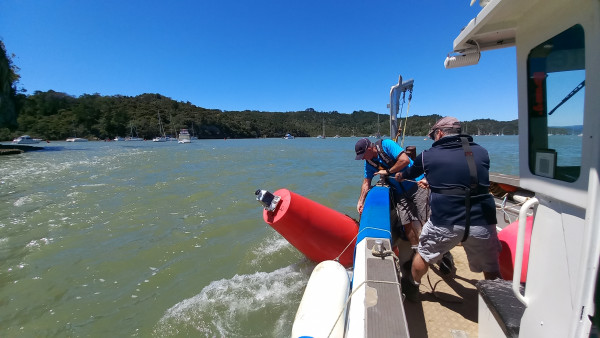 Waikato Regional Council maritime officers reposition a channel marker moved by strong and unusual currents.