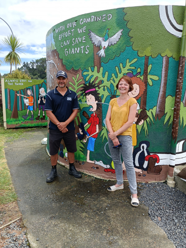 Kauri Protection Biosecurity Officer Hirini Rolleston (left) with mural artist Rebekah Pearson.